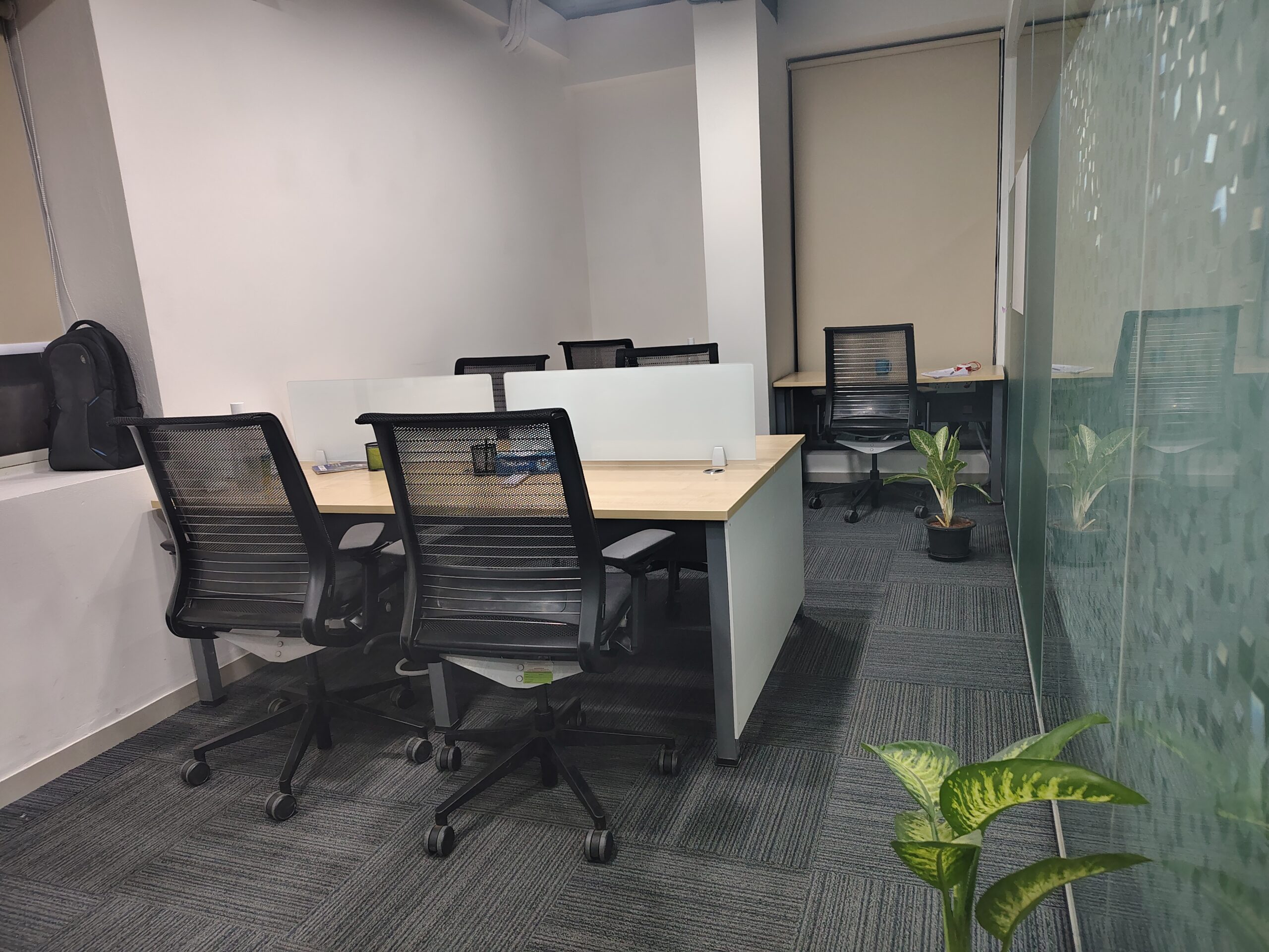 A spacious eight seater private cabin at Elite Co-Works, BTM Layout, Bangalore, designed for privacy and productivity, featuring individual workstations, ergonomic chairs, ample lighting, air conditioning, and a quiet ambiance — ideal for growing teams seeking a premium coworking environment with dedicated office space.